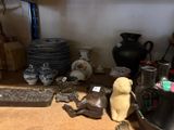 a table with a lot of vases and other items on it