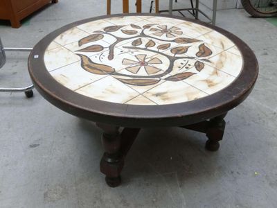a table with a flower design on it in the middle of a room