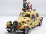 a toy car with a man sitting on top of it