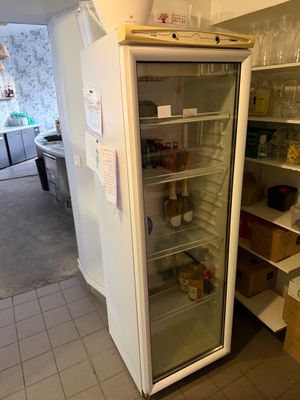 a refrigerator with a glass door in a kitchen