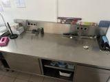 a stainless steel counter top with a sink and a dishwasher