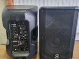 two speakers sitting on top of a table next to each other