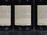 three bottles of wine sitting on top of a table next to each other