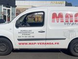 une camionnette blanche garée devant un bâtiment