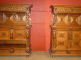 pair of antique carved wood nightstands with drawers in a red room