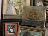 a box full of assorted framed and unframed art