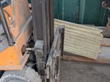 a forklift truck that is parked next to a building