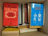 many books that are in a box on the shelf