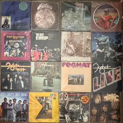 an image of a wall covered with various albums and cds