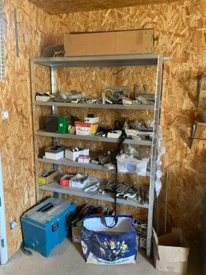 a room with a shelf with tools on it