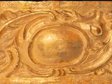 a gold plate with a decorative design on it