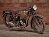 a old motorcycle that is parked in front of a brick wall