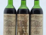 trois bouteilles de vin posées sur une table l'une à côté de l'autre