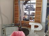 a pink basket sitting on a table next to a lamp