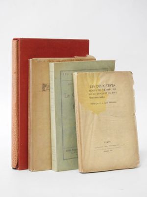 several old books are stacked on top of each other on a white surface