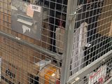 a large metal cage with luggage on top of it