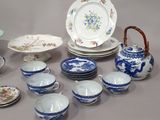 a lot of plates and bowls that are on the table