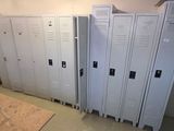 several white lockers are lined up against a wall in a room