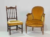 pair of antique chairs with yellow upholstered cushions in a white room
