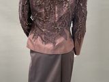 an image of a mannequin wearing a brown jacket and skirt