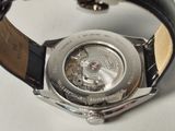 a close up of a watch on a white surface