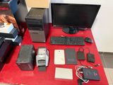 a red table with a computer and other electronics on it