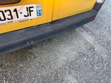 a close up of a yellow car with a number plate on it