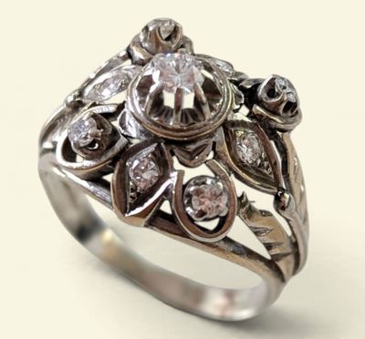 a close up of a ring with diamonds on a white background