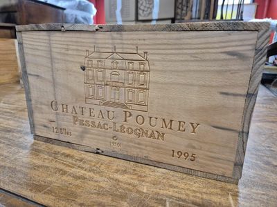 une boîte en bois posée sur une table, sur laquelle figure un logo