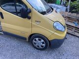 a small yellow van that is parked in the parking lot