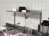 a kitchen with a stove, sink, and a blender