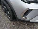 a close up of the front bumper of a silver car