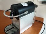 a coffee machine on a table with a cup on it