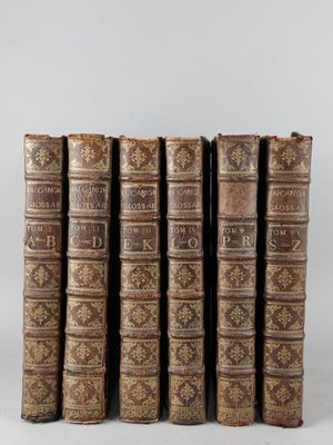 a set of five old books sitting on top of each other
