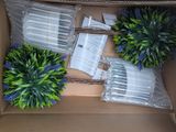 a cardboard box with a bunch of fake plants inside of it