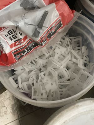 a plastic container filled with shredded paper on the floor