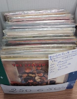 a lot of records in a box on the table