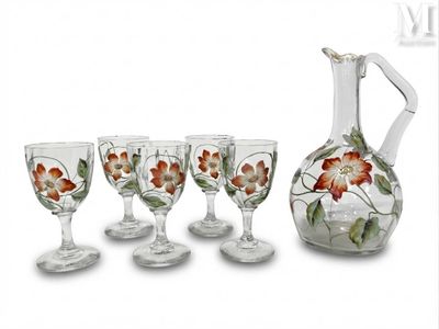 four wine glasses and a decanter set on the table