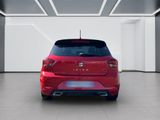the rear end of a red car in a white room