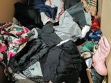 a cardboard box filled with clothes and a pair of shoes