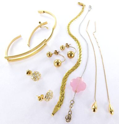 many different types of jewelry on a white surface