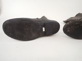 pair of brown leather shoes on a white surface with a white background