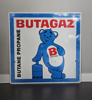 un panneau bleu et blanc sur lequel figure l'image d'un ours
