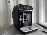 a black coffee machine sitting on a counter next to a window