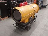 a large yellow barrel sitting on a cart in a warehouse