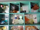 many different bottles of perfume in a blue box