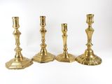 three brass candlesticks on a white background with a white background