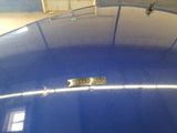 a close up of a blue car with a metal tag on it