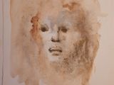 a painting of a woman ' s face on a piece of paper