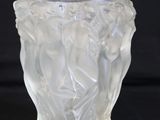 a glass vase with a design on it on a black background